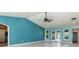 Living room with vaulted ceiling, light wood floors, and access to patio at 8516 Riverside Dr, Punta Gorda, FL 33982