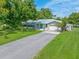 Single-story home with a screened porch and a teal front door at 8516 Riverside Dr, Punta Gorda, FL 33982