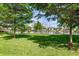 Lush green backyard with mature trees and waterfront views at 8516 Riverside Dr, Punta Gorda, FL 33982