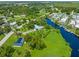Aerial view showing a waterfront property with a canal and surrounding neighborhood at 8516 Riverside Dr, Punta Gorda, FL 33982