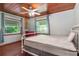 Bedroom with wood ceiling, large windows and a metal bed frame at 8516 Riverside Dr, Punta Gorda, FL 33982