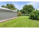 Large backyard with side yard and partial view of the canal at 8516 Riverside Dr, Punta Gorda, FL 33982