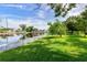 Peaceful canal front property with lush lawn and white picket fence at 8516 Riverside Dr, Punta Gorda, FL 33982