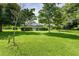Spacious backyard with a view of the house and surrounding greenery at 8516 Riverside Dr, Punta Gorda, FL 33982