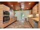 Renovated kitchen with wood cabinets, stainless steel appliances, and tile flooring at 8516 Riverside Dr, Punta Gorda, FL 33982