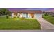 Charming single story home with teal door and landscaped yard at 5104 Chaves Cir, Port Charlotte, FL 33948