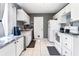 Open kitchen with white cabinets, granite counters and appliances at 5104 Chaves Cir, Port Charlotte, FL 33948