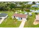 Aerial view of a single-Gathering house with a large backyard and canal views at 5104 Chaves Cir, Port Charlotte, FL 33948