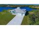 Waterfront home with a metal roof, two-car garage, and expansive yard at 2239 Cornelius Blvd, Port Charlotte, FL 33953
