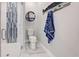 Updated bathroom with walk-in shower, tile flooring, and stylish wall decor at 2239 Cornelius Blvd, Port Charlotte, FL 33953