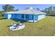 Single-Gathering home with a metal roof, covered patio, and fire pit at 2239 Cornelius Blvd, Port Charlotte, FL 33953