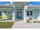 Inviting front porch with yellow rocking chairs, perfect for relaxing at 2239 Cornelius Blvd, Port Charlotte, FL 33953