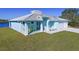 Exterior of charming light blue home with front porch and two rocking chairs at 2239 Cornelius Blvd, Port Charlotte, FL 33953
