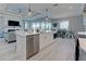 White kitchen island with seating and stainless steel appliances at 2239 Cornelius Blvd, Port Charlotte, FL 33953