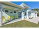 Charming front porch features yellow rocking chairs and a welcoming atmosphere at 2239 Cornelius Blvd, Port Charlotte, FL 33953