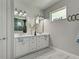 Double vanity bathroom with modern white cabinets and quartz countertop at 2239 Cornelius Blvd, Port Charlotte, FL 33953