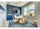 Bright dining area with round table and chairs, blue accent wall at 2239 Cornelius Blvd, Port Charlotte, FL 33953