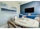 Round dining table with chairs in a room with a blue accent wall at 2239 Cornelius Blvd, Port Charlotte, FL 33953