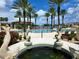 Large resort-style pool with palm trees and fountain at 96 Vivante Blvd # 96211, Punta Gorda, FL 33950