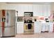 Bright kitchen with stainless steel appliances and white cabinetry at 96 Vivante Blvd # 96211, Punta Gorda, FL 33950