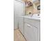 Laundry room with washer, dryer, and shelving at 96 Vivante Blvd # 96211, Punta Gorda, FL 33950