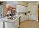 Kitchen features white cabinets, a large island, and stainless steel appliances at 96 Vivante Blvd # 96211, Punta Gorda, FL 33950