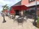 Restaurant patio with tables and red umbrellas at 96 Vivante Blvd # 96211, Punta Gorda, FL 33950