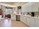 Modern kitchen with white cabinets, stainless steel appliances and breakfast nook at 96 Vivante Blvd # 96211, Punta Gorda, FL 33950