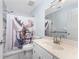 Cozy bathroom featuring a vanity with a solid surface top and a whimsical moose shower curtain at 7456 Jennifer Dr, Port Charlotte, FL 33981