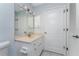 Bathroom featuring a vanity with a solid surface top and a mirror with Hollywood style lighting at 7456 Jennifer Dr, Port Charlotte, FL 33981