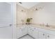 The renovated bathroom features modern lighting, plenty of cabinet space and a designer vanity at 7456 Jennifer Dr, Port Charlotte, FL 33981