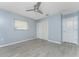 This bright bedroom features luxury vinyl plank flooring, a ceiling fan and a large closet at 7456 Jennifer Dr, Port Charlotte, FL 33981