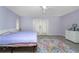 This bright bedroom offers an overhead ceiling fan and access to a private balcony via sliding glass doors at 7456 Jennifer Dr, Port Charlotte, FL 33981
