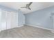 This empty bedroom has new vinyl plank flooring, a ceiling fan and a large closet for ample storage at 7456 Jennifer Dr, Port Charlotte, FL 33981
