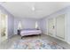 This charming bedroom features an overhead ceiling fan and large sliding glass doors to a balcony at 7456 Jennifer Dr, Port Charlotte, FL 33981