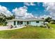 Charming single-story home with a well-manicured lawn and a welcoming, curved walkway leading to the front entrance at 7456 Jennifer Dr, Port Charlotte, FL 33981
