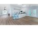 Open concept kitchen with island and bar seating, seamlessly connected to the living area at 7456 Jennifer Dr, Port Charlotte, FL 33981