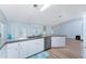 Bright kitchen features white cabinets, stainless steel appliances, and lots of natural light at 7456 Jennifer Dr, Port Charlotte, FL 33981