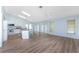 Bright, open-concept kitchen with an island flows into a spacious living area with ample natural light at 7456 Jennifer Dr, Port Charlotte, FL 33981