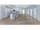 Modern kitchen with white cabinets, island with seating, and double doors to the patio at 7456 Jennifer Dr, Port Charlotte, FL 33981