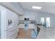 Kitchen features white cabinets, stainless steel appliances, and a tile backsplash at 7456 Jennifer Dr, Port Charlotte, FL 33981