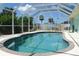 Enjoy this refreshing enclosed pool surrounded by abundant greenery at 7456 Jennifer Dr, Port Charlotte, FL 33981