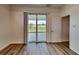 Bright bedroom with wood-look flooring and access to a patio at 16216 Minorca Dr, Punta Gorda, FL 33955