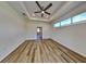 Spacious bedroom with wood-look floors and ceiling fan at 16216 Minorca Dr, Punta Gorda, FL 33955