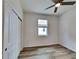 Bright bedroom with wood-look floors and ceiling fan at 16216 Minorca Dr, Punta Gorda, FL 33955