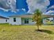 Home with covered patio and grassy backyard at 16216 Minorca Dr, Punta Gorda, FL 33955