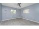 Spacious bedroom with wood-look floors and a ceiling fan at 7456 Jennifer Dr, Port Charlotte, FL 33981