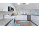 Modern kitchen with white cabinets, stainless steel appliances, and wood-look flooring at 7456 Jennifer Dr, Port Charlotte, FL 33981