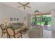 Living room with patio doors opening to a lush backyard at 1112 W Hillsborough Blvd, North Port, FL 34288