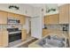 Well-equipped kitchen featuring stainless steel appliances and wood cabinetry at 1112 W Hillsborough Blvd, North Port, FL 34288